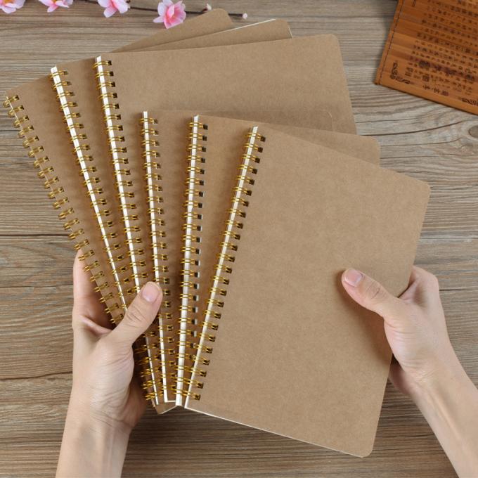 Aufbereitetes kundenspezifisches Großhandelsgitter der gebundenen Ausgabe zeichnete gewundenes A5 Kraftpapier des freien Raumes Notizbuch Offic